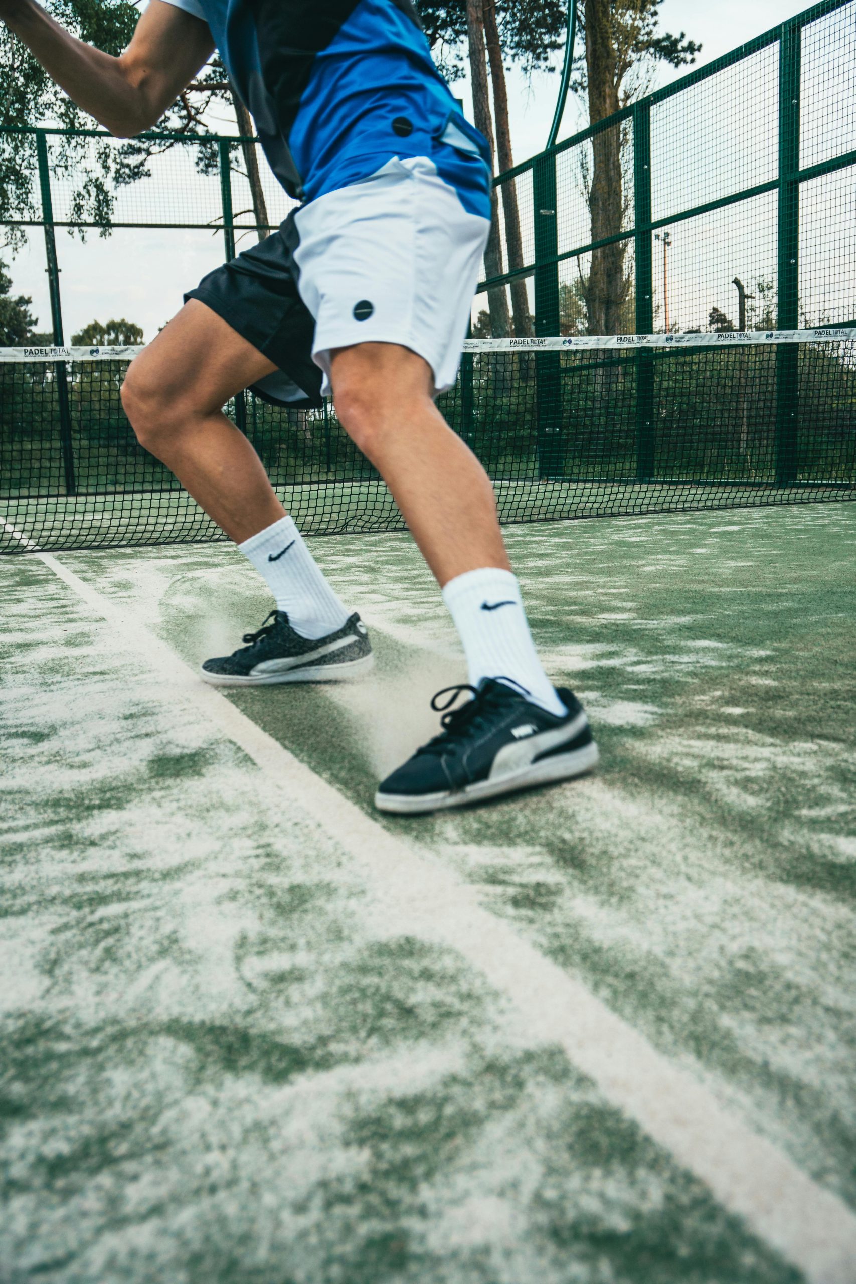 Captivating shot of a male tennis player in motion during a game on an outdoor court in Sweden.